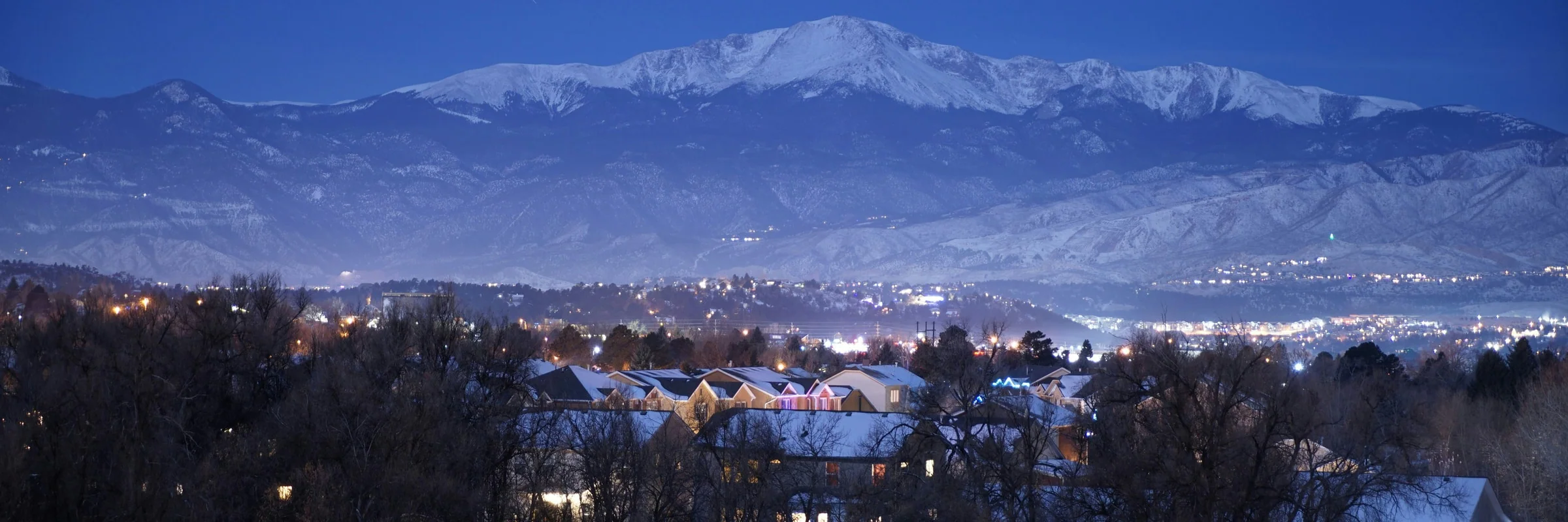 Pikes Peak and Colorado Springs at dusk after snowfall